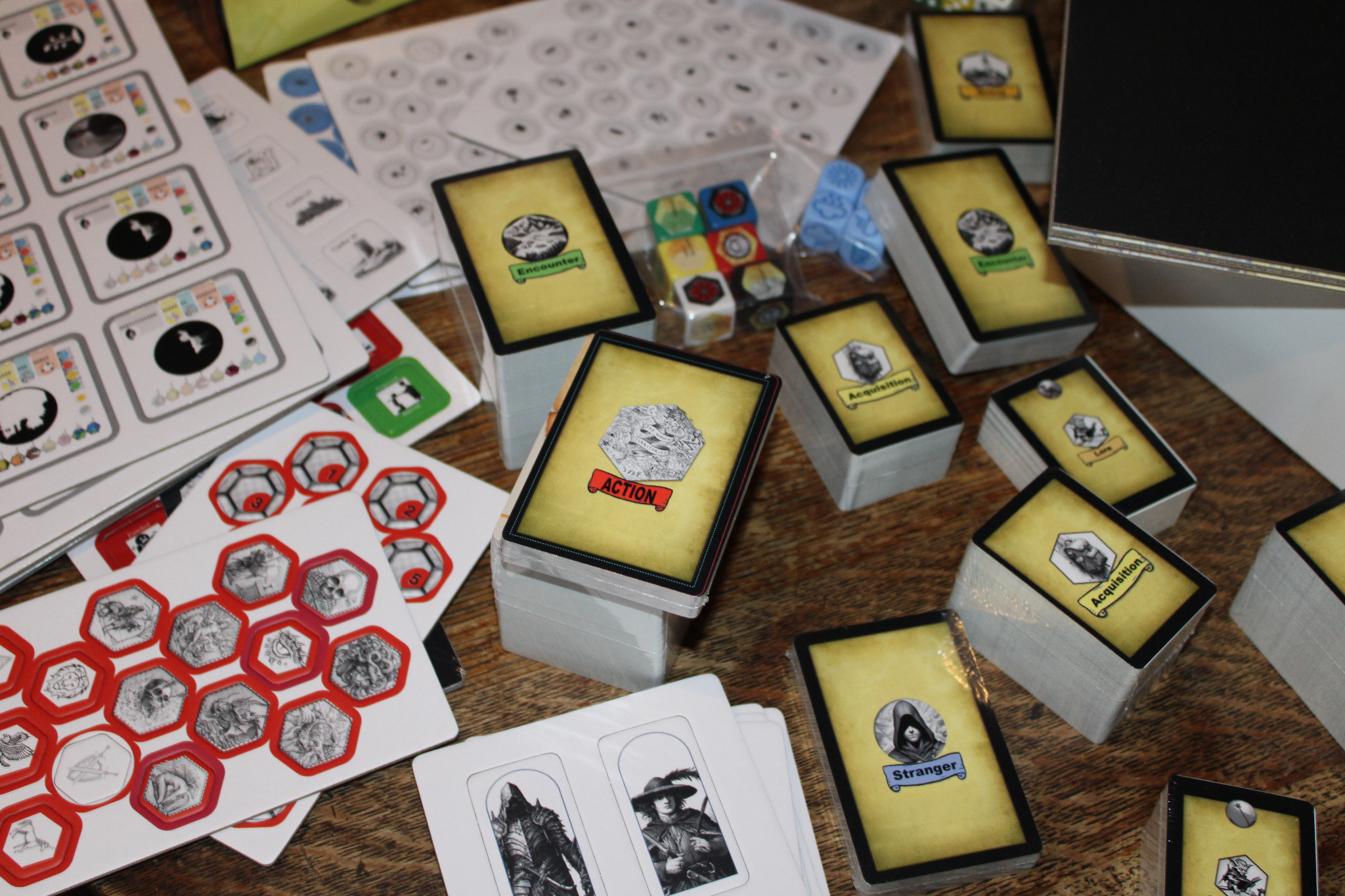 Action, Encounter, Stranger and Acquisition card decks, dice, tokens and player materials.