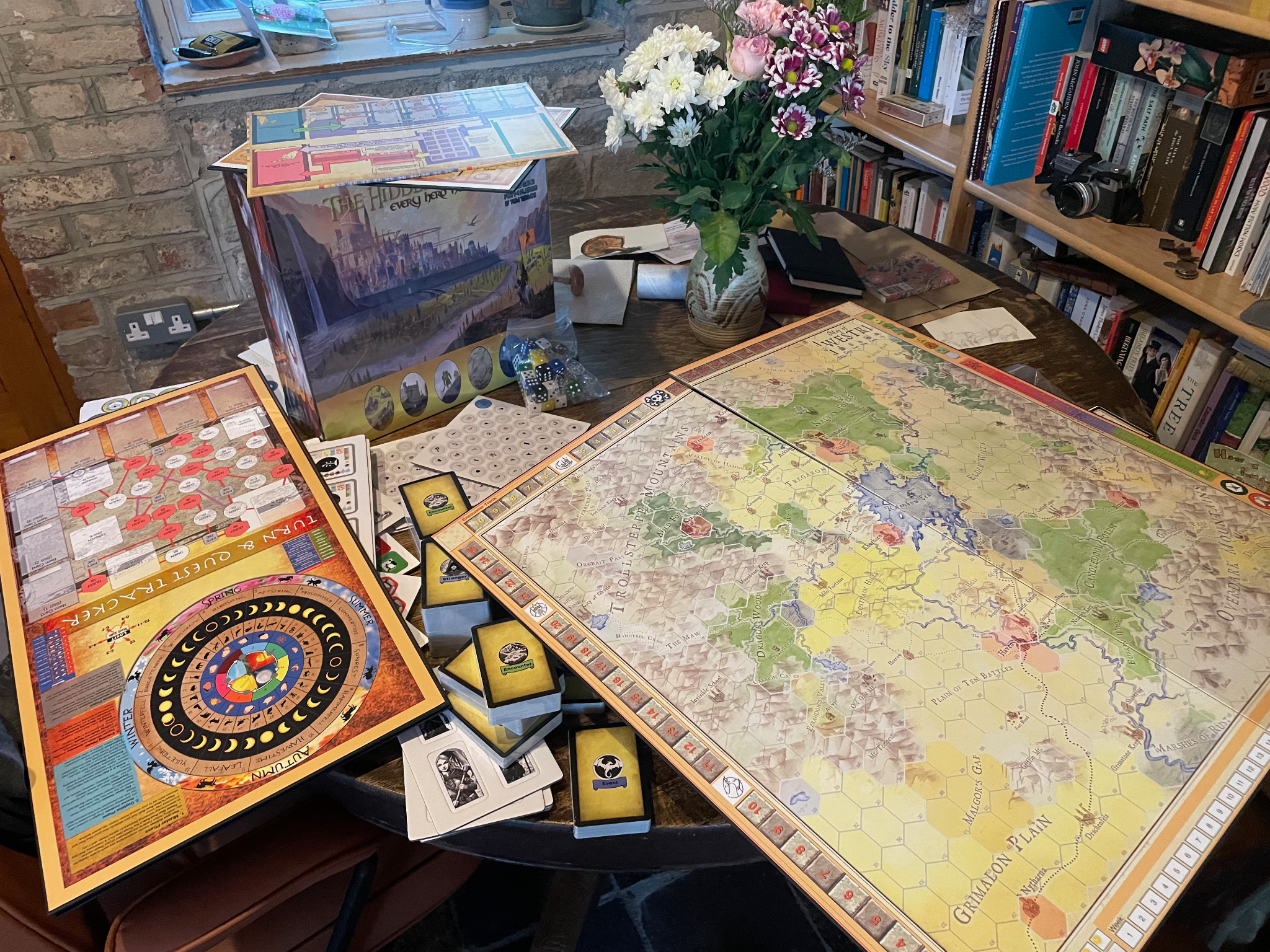 The Hidden Territories prototype spread across a table, including the Westri map, trackers, cards, dice and game box.
